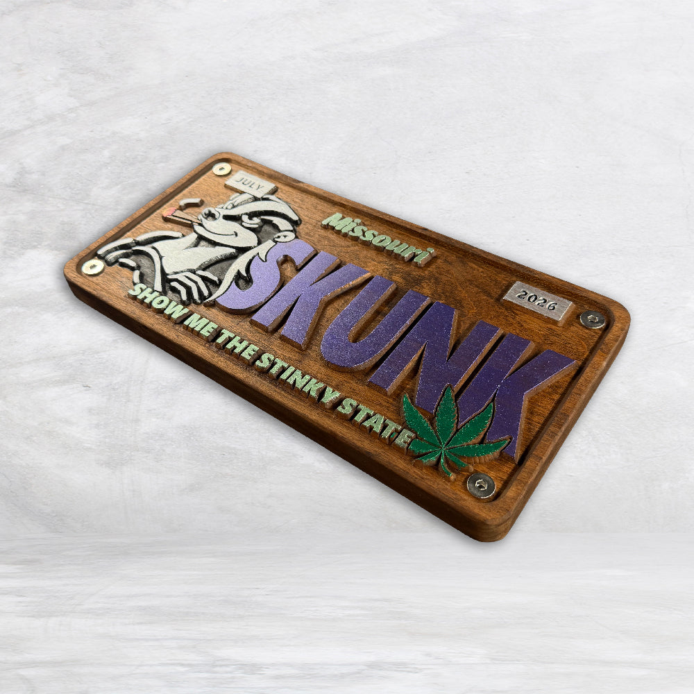 Precision carved cherry wood Missouri license plate with purple SKUNK lettering skunk and cannabis leaf artwork hand stained painted and finished in USA