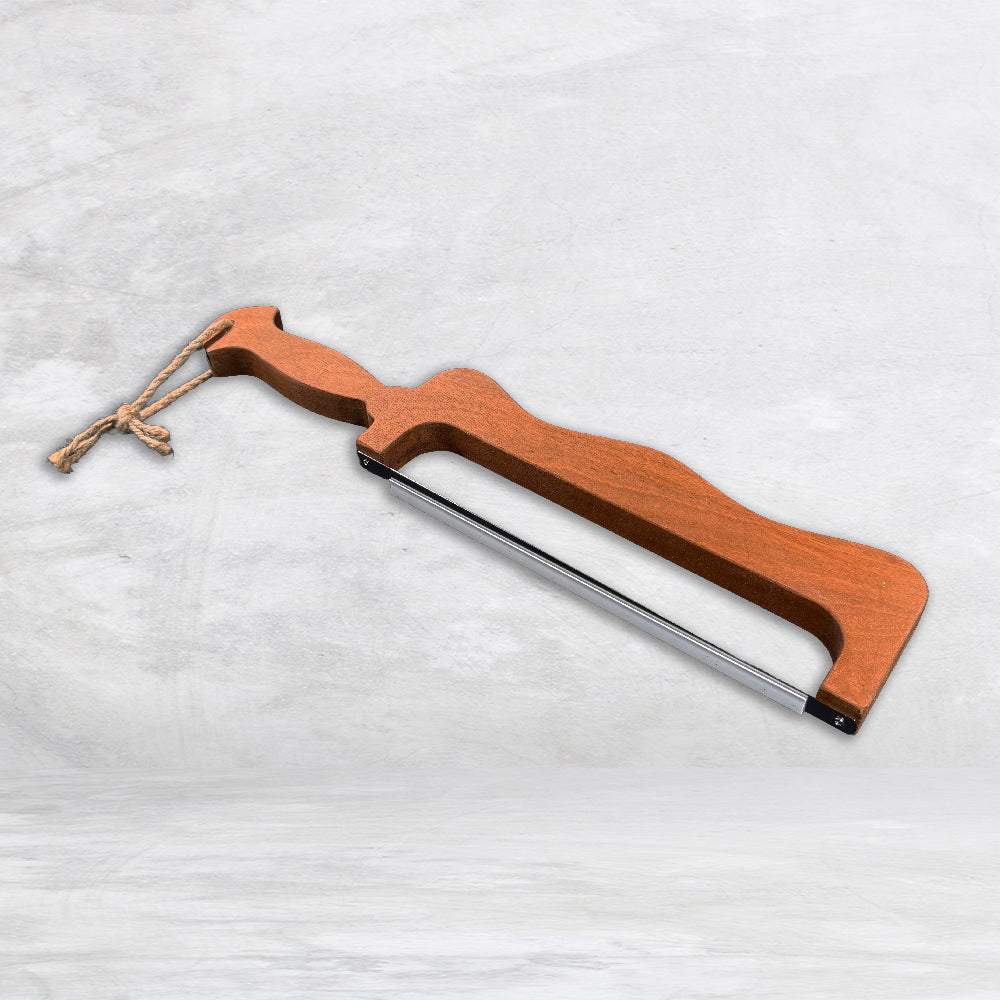 Hand finished solid cherry wood bread slicer with precision carved handle and stainless steel blade, crafted in USA for unique kitchen accessories.