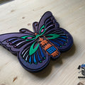 Hand stained and painted precision carved wood butterfly featuring vibrant colors and high detail, handcrafted in the USA for unique wood art decor.